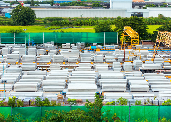 Large outdoor storage yard with concrete construction materials.